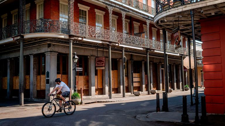 A man cycles along Jackson Square in New Orleans, Louisiana, on March 26, 2020