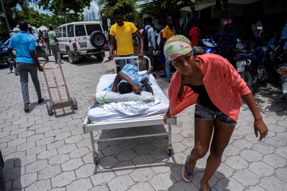 A woman injured in the earthquake is transported to a hospital, in Les Cayes, Haiti Aug. 16.