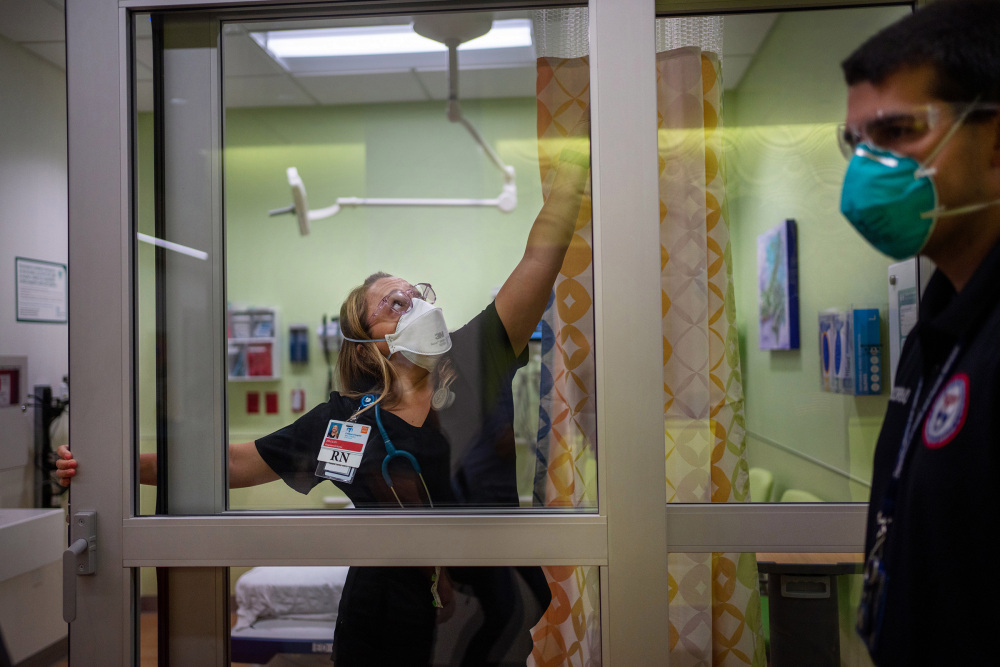 Jillian Nickerson tries to fix a stuck door in a newly opened room in the emergency department at Childrenâ€™s Hospital New Orleans on Aug. 20, while Paul Decerbo from the Rhode Island-1 Disaster Medical Assistance Team looks on.