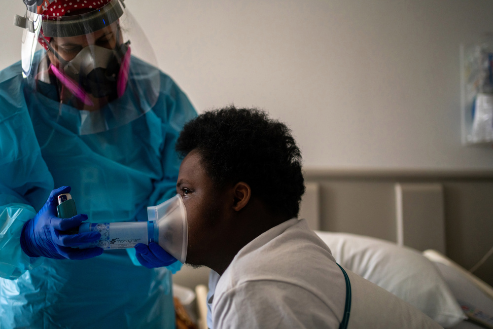 Nelson Alexis III, 17, undergoes respiratory therapy in his room at Childrenâ€™s Hospital New Orleans. Nelson, who has Down syndrome, was diagnosed with the virus in late July.