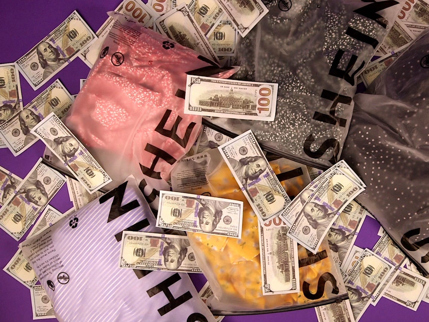 Shein packages with clothes inside, $100 bills thrown on top