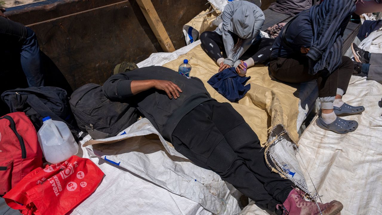 A traveler rests on the cargo. There is no shelter from the sun, wind and nighttime cold, but these open trucks are preferred as they offer some protection from falling off.