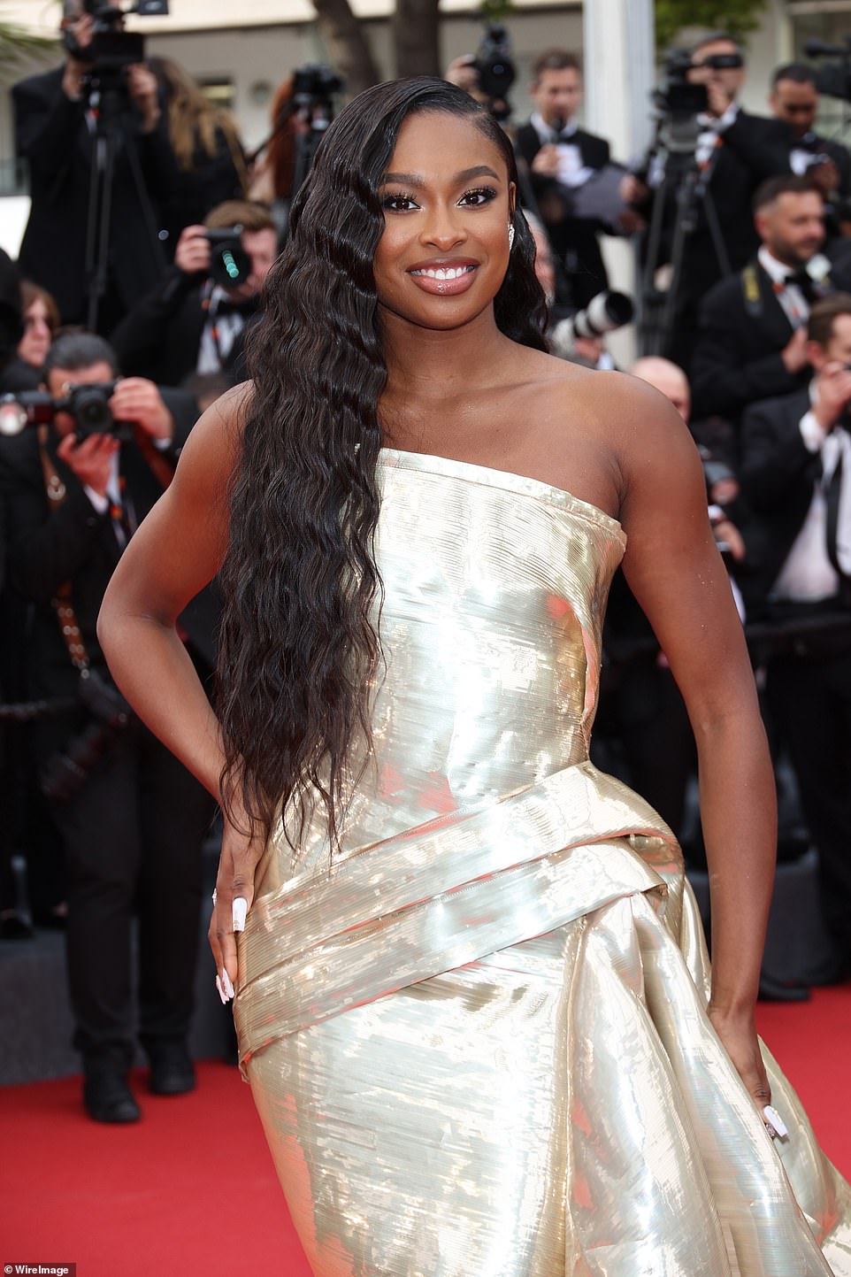 Glowing: Coco put on a stunning display in the strapless shiny gown