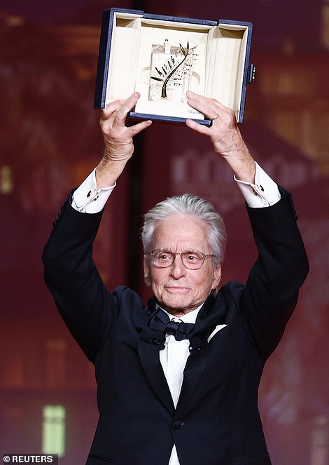 Hurrah! Michael Douglas holds up the Honorary Palme d'Or Award