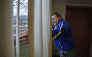 John Stasiulewicz, head of security for the Jefferson Metropolitan Housing Authority in Steubenville, checks an unlocked window on a property.