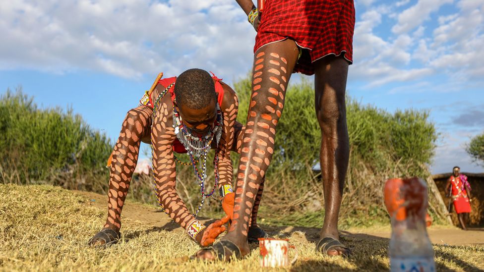 Members of the Maasai community paint their legs for the inaugural Maasai Cultural Festival at the Sekenani village, Kenya - Saturday 10 June 2023