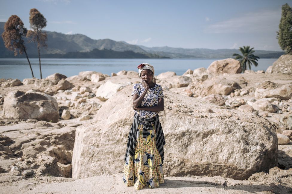 A woman poses on the site of her house that was swept away in floods in Bushushu village, DR Congo - Friday 9 June 2023