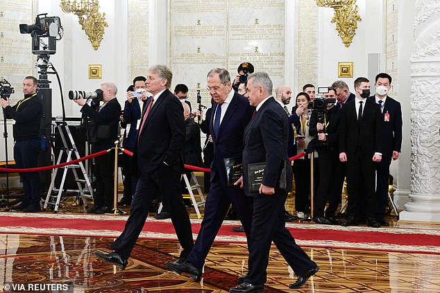 Whenever Russia's defeat comes, Mr Coffey argues it will divide the country's elites into two groups. Pictured: Kremlin spokesman Dmitry Peskov, Foreign Minister Sergei Lavrov and Defence Minister Sergei Shoigu walk in the Kremlin, March 21, 2023