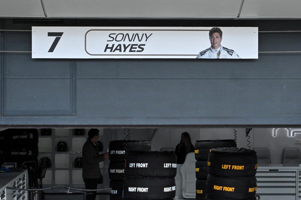 A plate bearing an image of US actor Brad Pitt, playing Sonny Hayes, the driver of the fictional Apex team in an F1-inspired movie, hangs above his fictional garage ahead of the Formula One British Grand Prix at the Silverstone motor racing circuit in Silverstone, central England on July 6, 2023. (Photo by Ben Stansall / AFP) (Photo by BEN STANSALL/AFP via Getty Images)