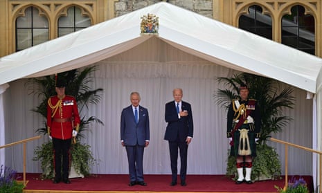 US president Joe Biden and King Charles on the dais, listen to the US national anthem played by the Band of the Welsh Guards, during a ceremonial welcome in the Quadrangle at Windsor Castle.