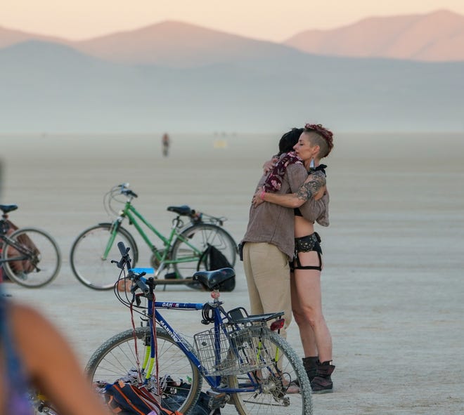 Shawn Gregory of El Salvador embraces Tanory Ateek of Washington, D.C. at Burning Man.