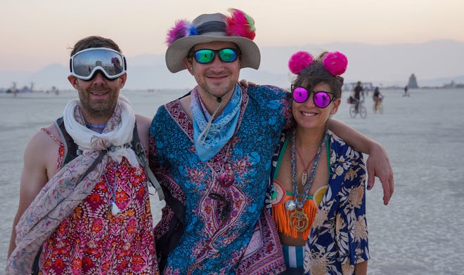 Paul Mandal of Denver, Stephan Marguet of Germany and Leah Johns of Portugal pose for a photo at Burning Man.