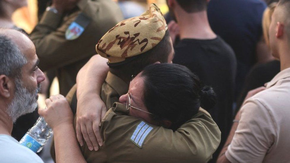 Two Israelis hug