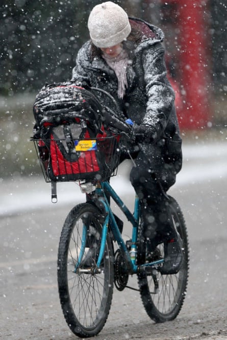 A cyclist as snow starts to fall