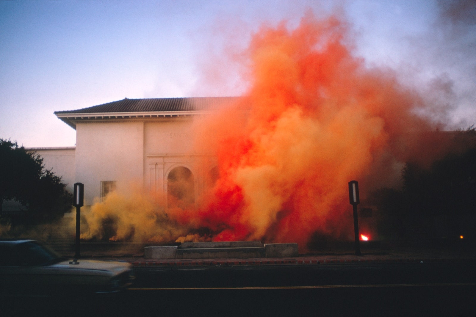 Orange smoke floats into the air.