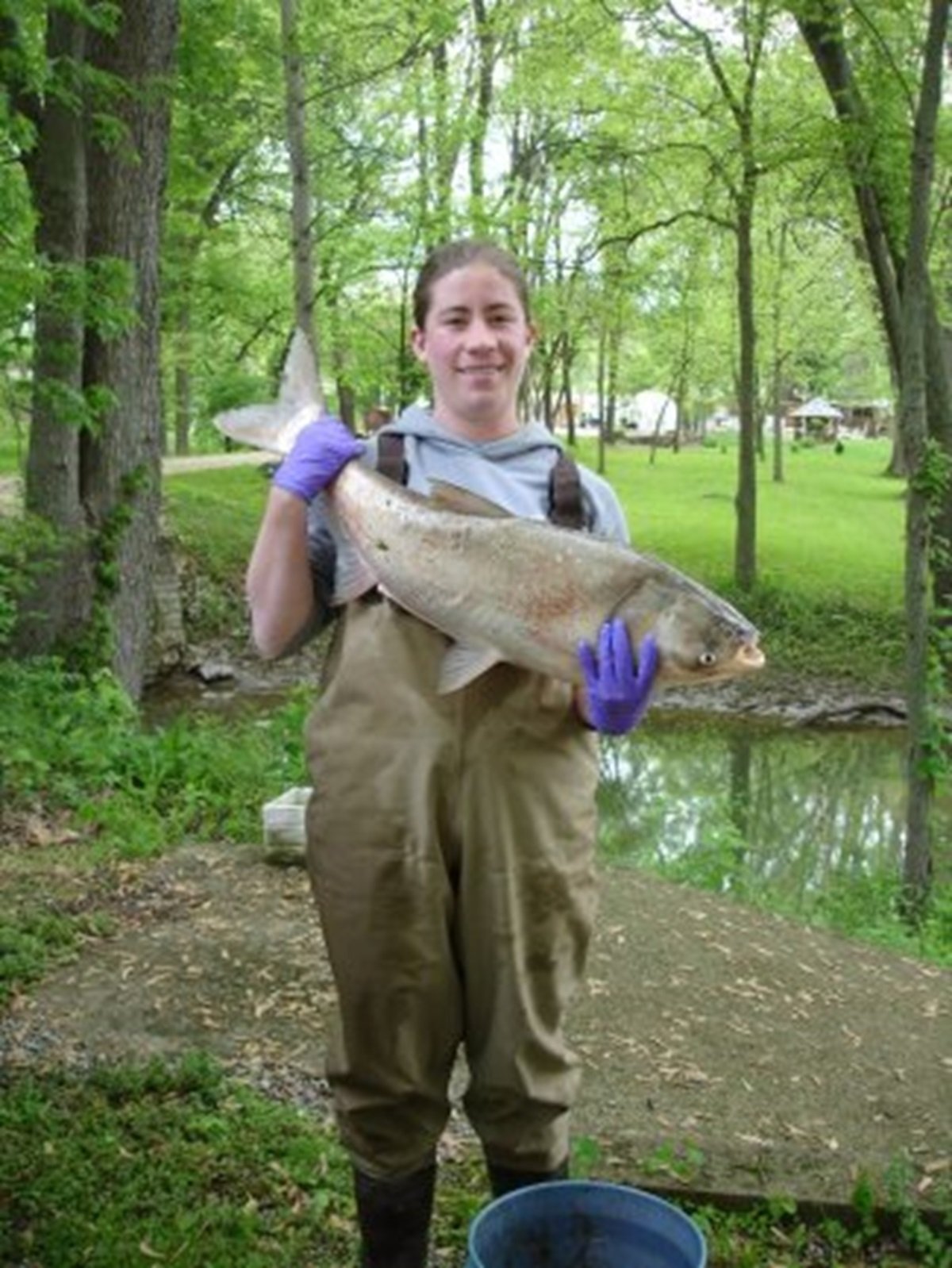 Alison Coulter with an invasive silver carp