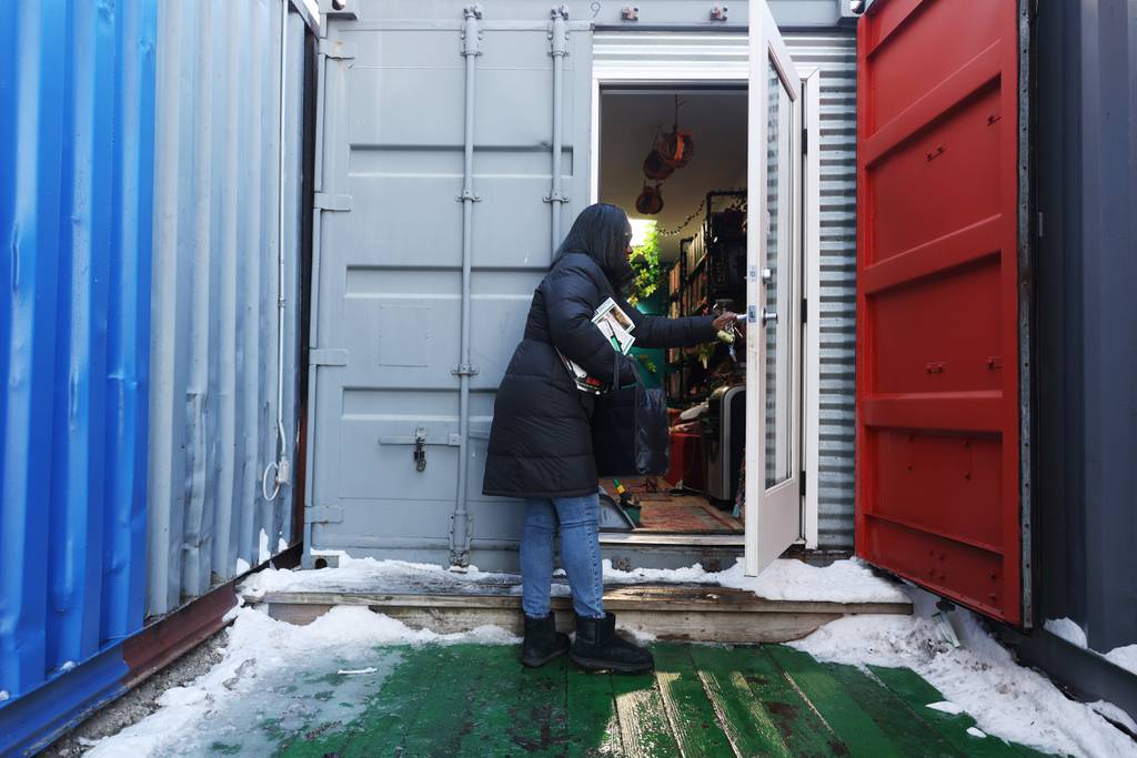 Verlean Singletary opens the door to Da Book Joint, 330 E. 51st St., Jan. 20, 2024, in Chicago. Its housed in a shipping container in Boxville.