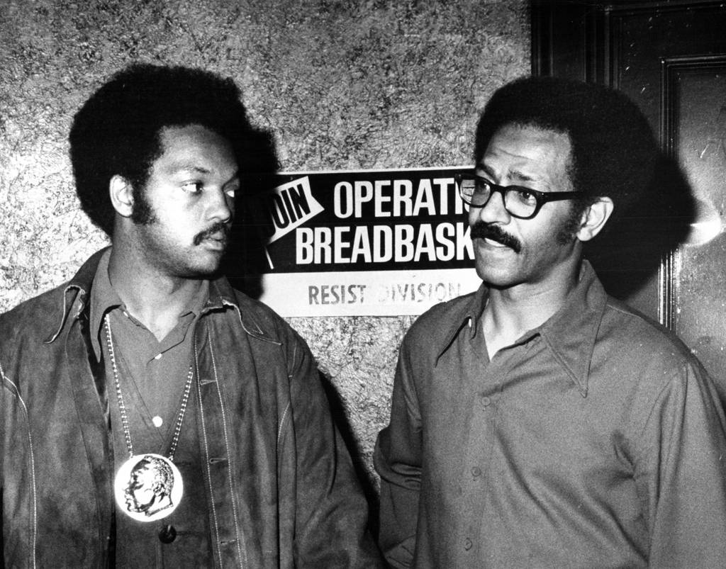 The Rev. Jesse Jackson, leader of Operation Breadbasket, left, goes over notes with St. Clare Booker, Breadbasket program director, on June 9, 1971, at 7941 S. Halsted St. in Chicago, as they plan their picket of all National Tea Stores.