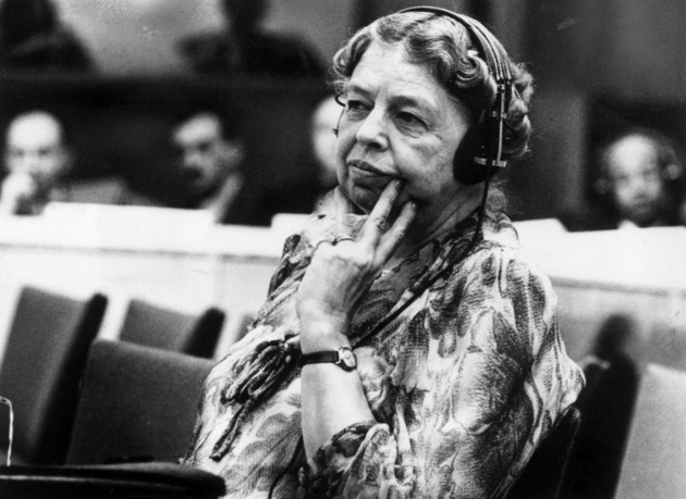Eleanor Roosevelt listens via headphones at a conference.