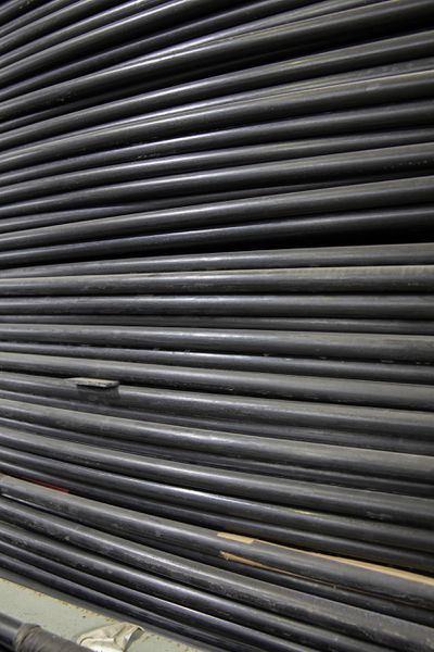 A side view of coiled submarine fiber optic cables,  giving the viewer the impression of a corrugated door.