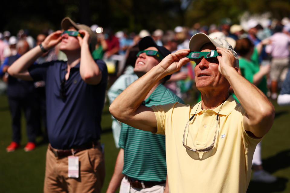 AUGUSTA, GEORGIA - APRIL 08: Patrons use glasses the view the eclipse prior to the 2024 Masters Tournament at Augusta National Golf Club on April 08, 2024 in Augusta, Georgia. (Photo by Maddie Meyer/Getty Images)