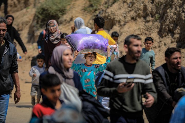 Displaced Palestinians attempting to return to their homes in north Gaza through a coastal road in the Gaza Strip on April 14, 2024.