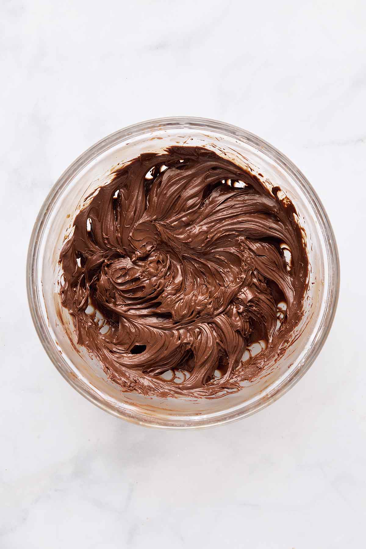 A bowl of chocolate frosting.