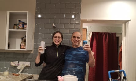 Natacha celebrates with her dad, John, after they finished tiling a kitchen in August 2021.