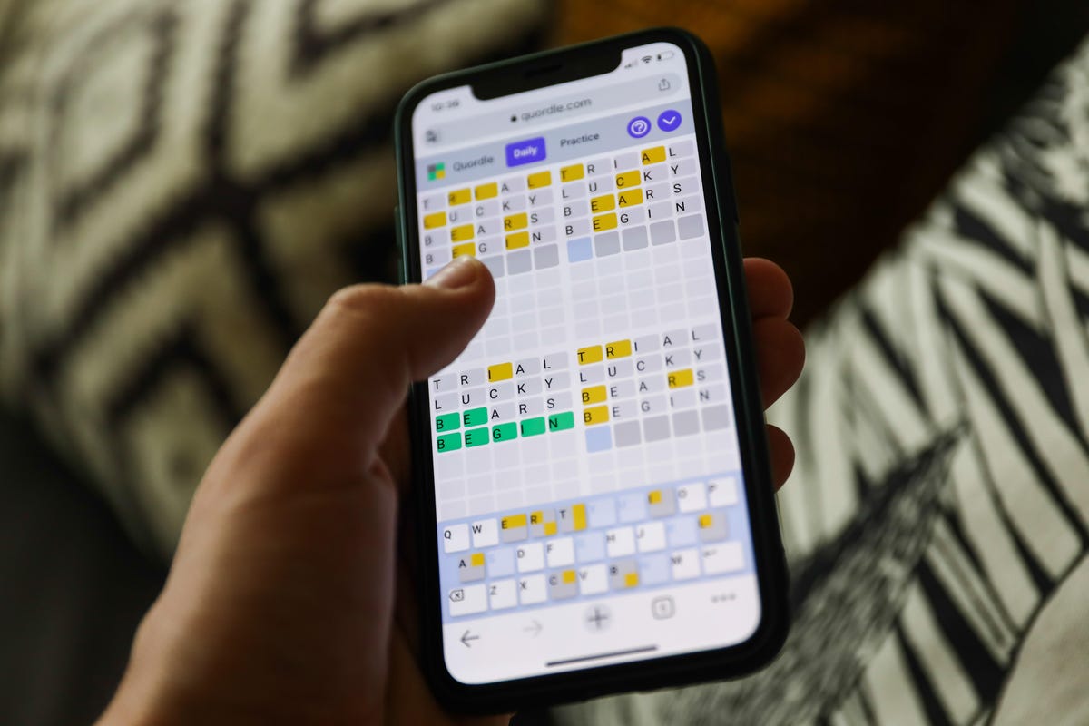 A person playing Quordle on their phone