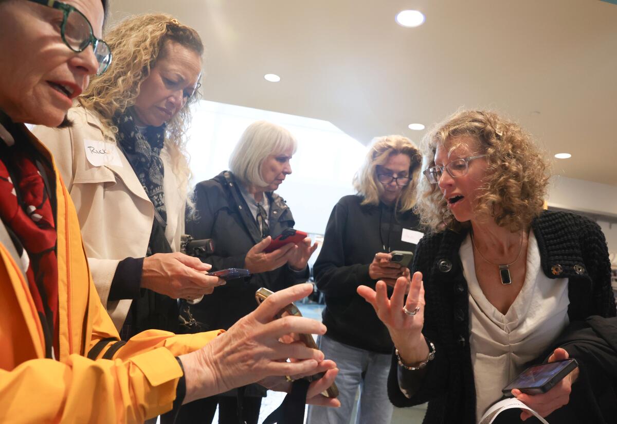 Gwen Shaffer, far right, guides data walk participants through a questionnaire in Long Beach.