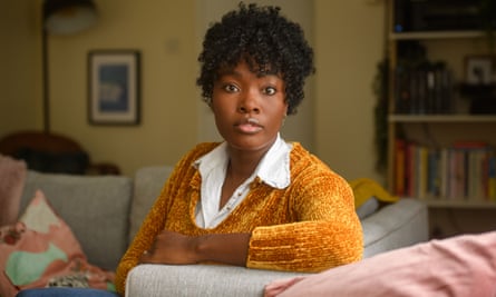 Kerry-Ann Knight looks at the camera while sitting on a sofa