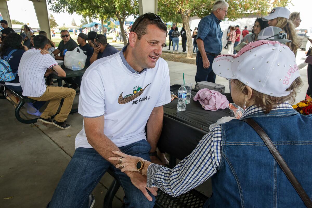 Rep. David Valadao meets with a constituent at a picnic table. 