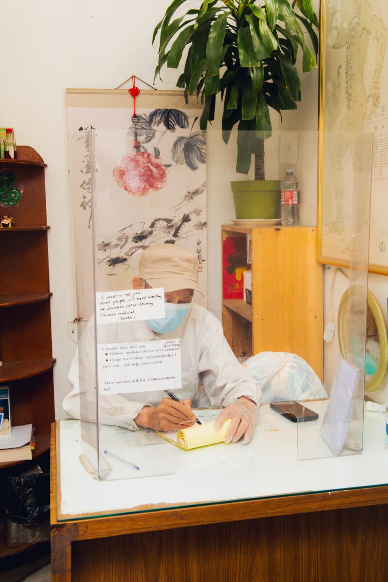 Huang at his desk inside the clinic.