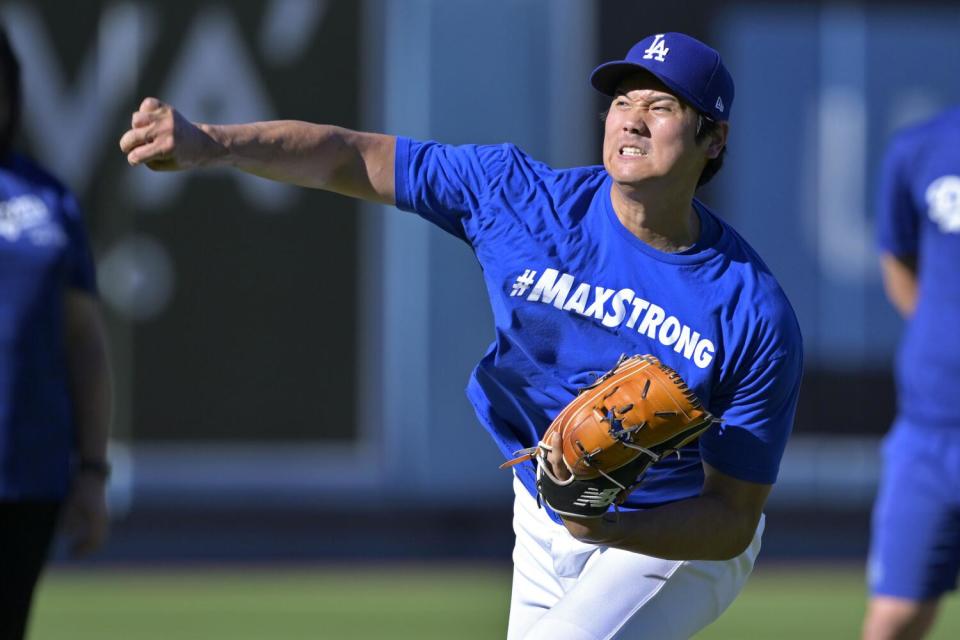 The Dodgers' Shohei Ohtani throws in the outfield prior to a game against the Seattle Mariners on Aug. 20.