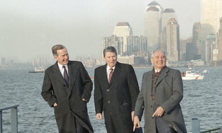 three men in overcoats with city skyscrapers in the background