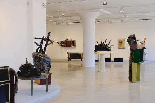 Overview of Greene Naftali Gallery with sculptures on tables, on pedestals and coming out of dressers.