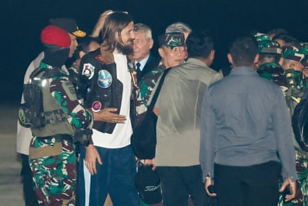 Mehrtens, surrounded by others, arrives at Halim Perdanakusuma airbase in Jakarta on Sunday after being freed from captivity