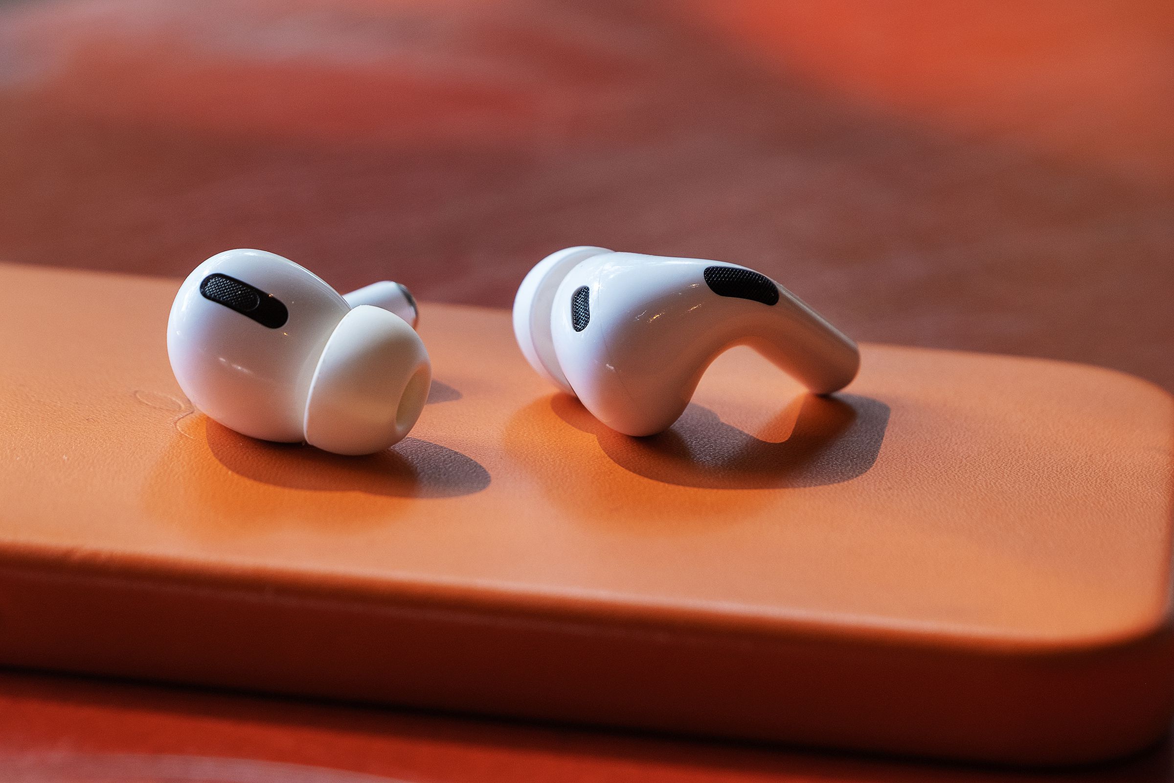 AirPods Pro 2022 model sitting on an orange pedestal.