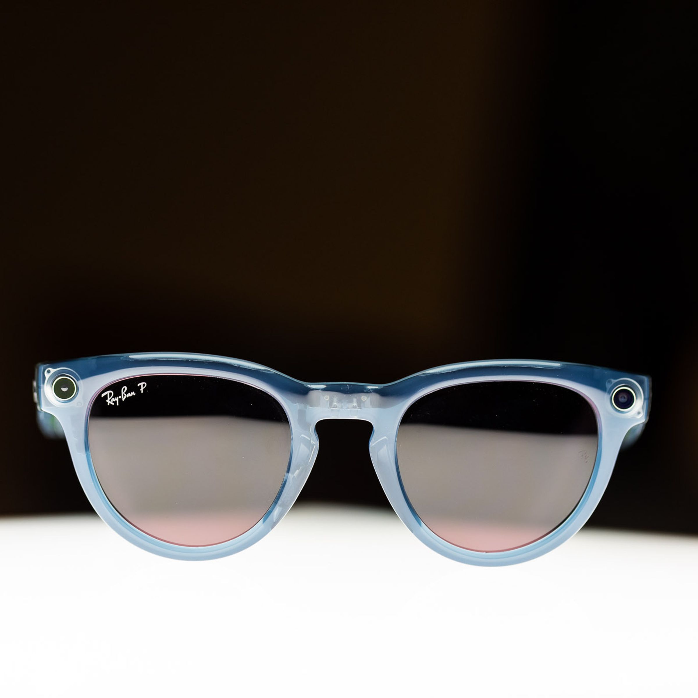 Pair of Ray-Ban Meta Smart Glasses illuminated from below