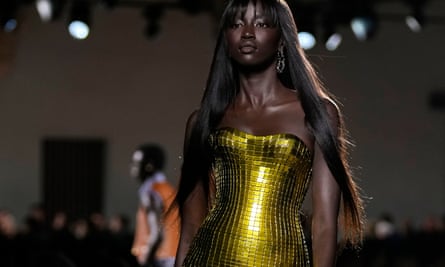 A model in a gold metallic dress.