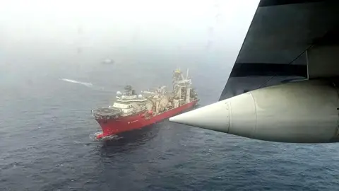 EPA Photo taken from an airplane flying over the sea, searching for the Titan. A number of boats are sailing in the sea below.