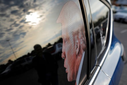 Trump in profile is seen on a car's back driver's side window.