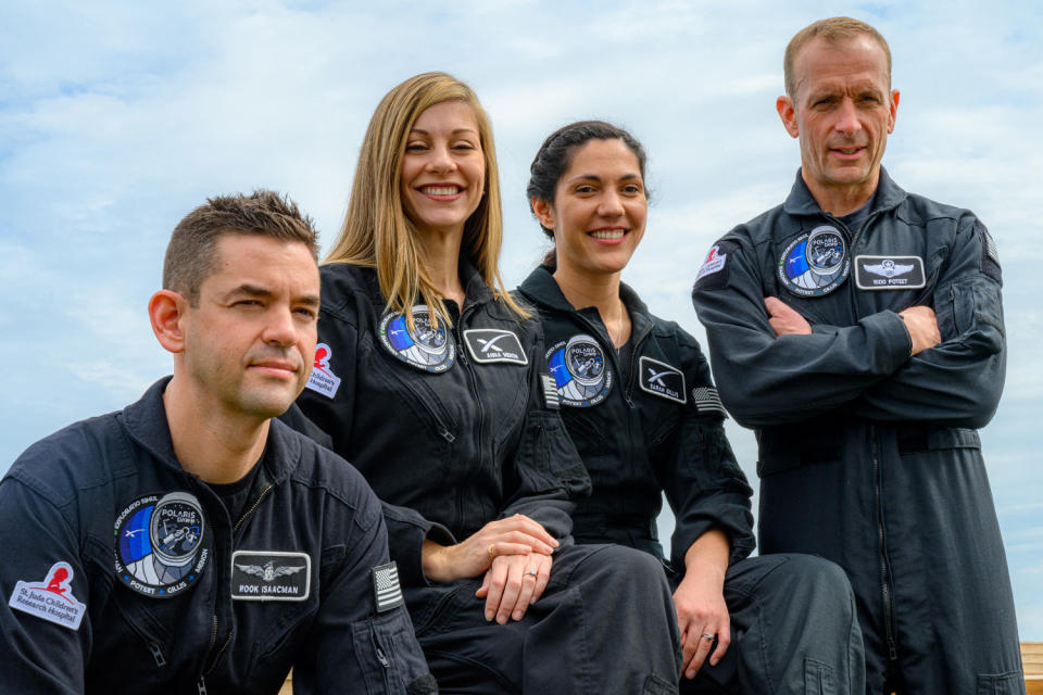 The four crew members smiling as they pose for a photo (Polaris Program)