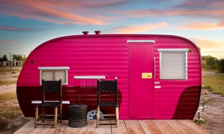 A hot pink caravan on a campsite