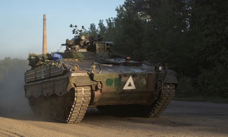 A Ukrainian armoured personnel carrier on dusty road