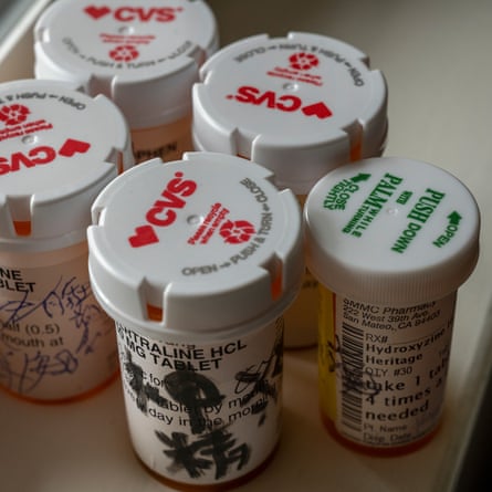 Five pill bottles with CVS caps.