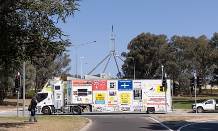 A semi-trailer covered in signs