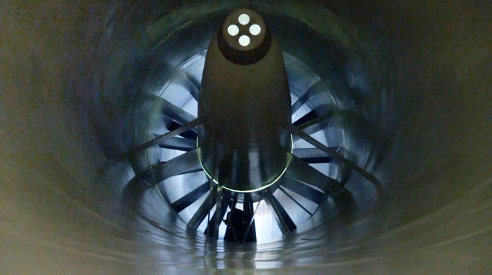 A tunnel with a circle of blades at the end.