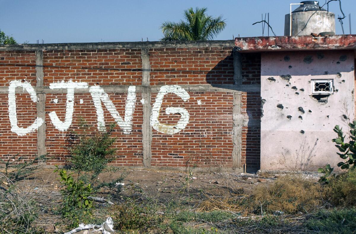 Graffiti on a wall says "CJNG."