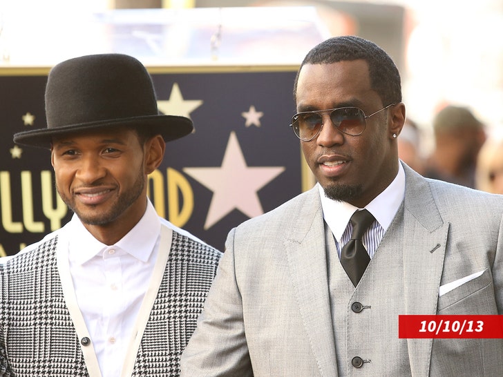 Usher, wearing a white shirt and top hat, standing next to Diddy, who's wearing sunglasses, shirt and tie, vest, and coat.